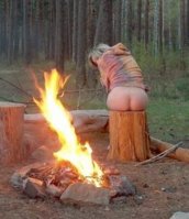 nude_warming_her_bottom_at_campfire.jpg